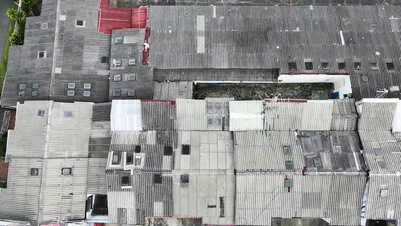 Top-down infrastructure inspection over industrial roofing.